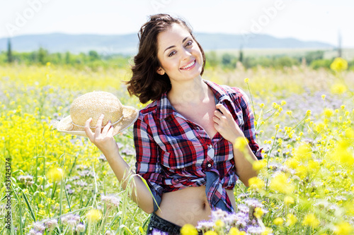 Photo: Portrait of young woman in the flowers field Portrait of young woman in the flowers field