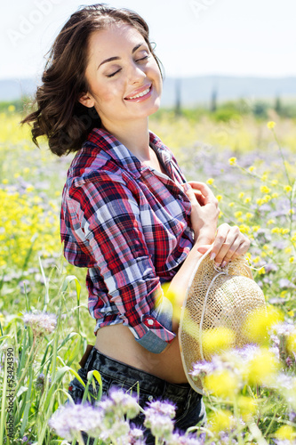 Photo: Portrait of young woman in the flowers field Portrait of young woman in the flowers field