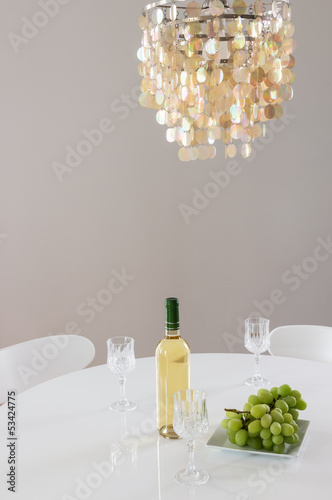 Photo: Decorative chandelier and bottle of wine on the table Decorative chandelier and bottle of wine on the table