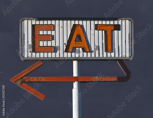 Photo: Vintage Eat Arrow Sign with Storm Sky Vintage Eat Arrow Sign with Storm Sky