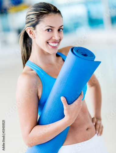 Photo: Gym woman holding yoga mat Gym woman holding yoga mat