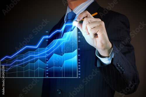 Photo: Business man drawing graphics Business man drawing graphics