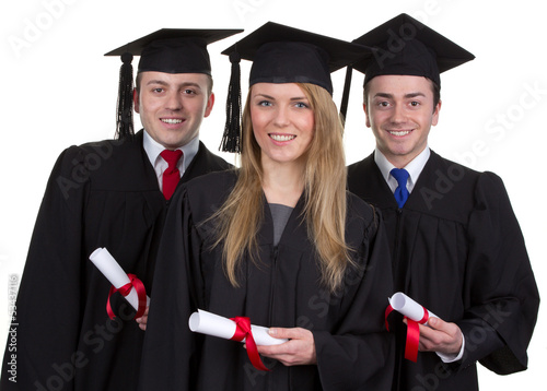 Photo: Three graduate with scrolls against a white background Three graduate with scrolls against a white background