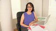 Portrait of young businesswoman at desk