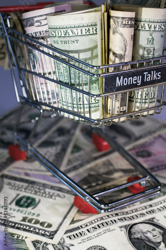 Photo: shopping trolley full dollar bill, greenback shopping trolley full dollar bill, greenback