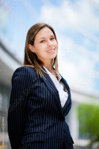 Photo: Beautiful young female executive in a modern setting Beautiful young female executive in a modern setting