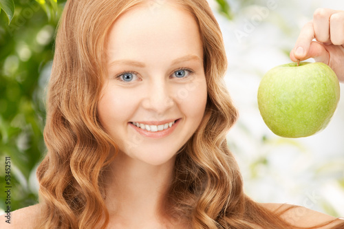 Photo: young beautiful woman with green apple young beautiful woman with green apple