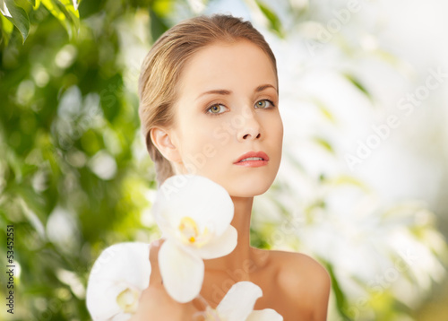 Photo: beautiful woman with orchid flower beautiful woman with orchid flower