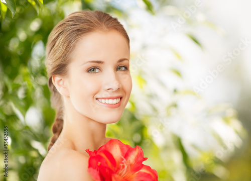 Photo: beautiful woman with red lily flower beautiful woman with red lily flower