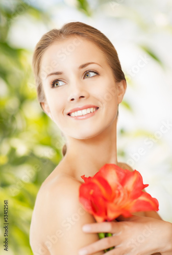 Photo: beautiful woman with red lily flower beautiful woman with red lily flower