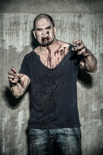 Photo: a scary and bloody zombie man a scary and bloody zombie man