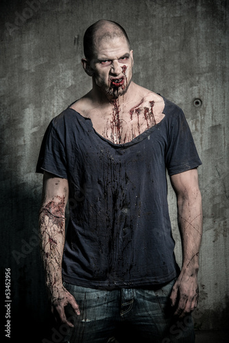 Photo: a scary and bloody zombie man a scary and bloody zombie man