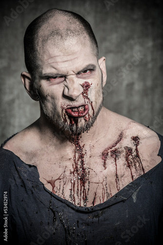 Photo: a scary and bloody zombie man a scary and bloody zombie man