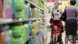 Mother with her boy in baby carriage in the supermarket