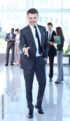 Photo: A business man with an open hand ready to seal a deal A business man with an open hand ready to seal a deal