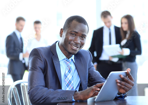 Photo: Portrait of a handsome young business man with a laptop Portrait of a handsome young business man with a laptop