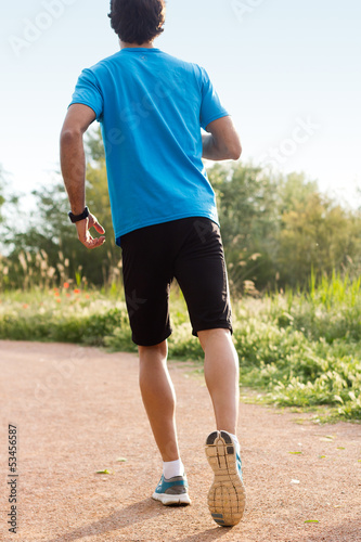 Photo: Man whit sportswear running in a park Man whit sportswear running in a park