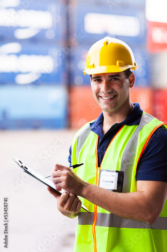 Photo: young shipping company worker at harbor container depot young shipping company worker at harbor container depot