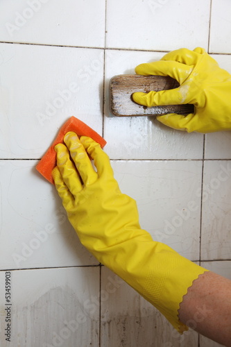 Photo: Cleaning of dirty old tiles in a bathroom Cleaning of dirty old tiles in a bathroom