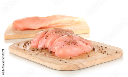 Photo: Chicken meat on board isolated on white Chicken meat on board isolated on white