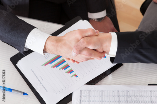 Photo: Two Business People Shaking Hands Two Business People Shaking Hands