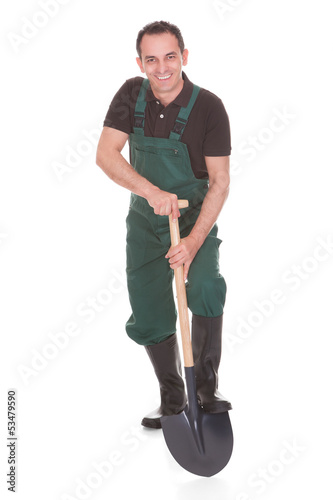 Photo: Portrait Of A Male Worker Holding A Shovel Portrait Of A Male Worker Holding A Shovel