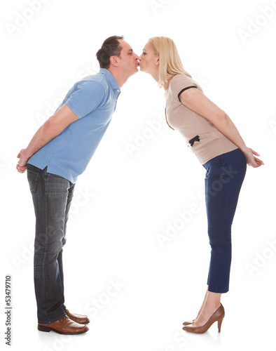Photo: Portrait Of Young Couple Kissing Portrait Of Young Couple Kissing