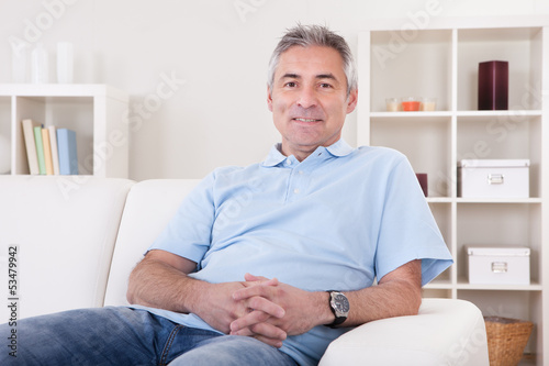 Photo: Mature Man Sitting On Sofa Mature Man Sitting On Sofa