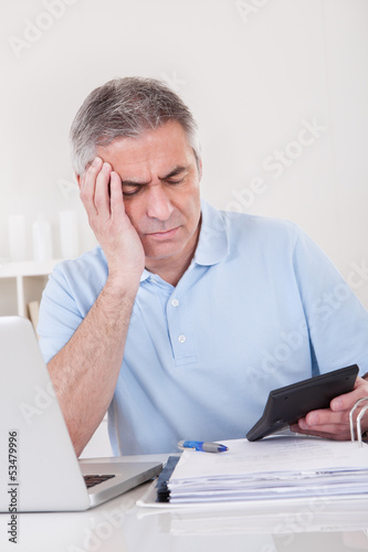 Photo: Mature Man Doing Finances Mature Man Doing Finances