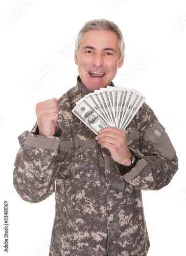 Photo: Happy Mature Soldier Holding 100 Dollar Bills Happy Mature Soldier Holding 100 Dollar Bills