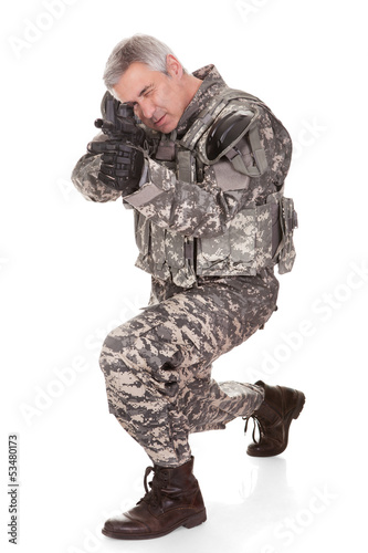 Photo: Mature Soldier Aiming With Rifle Mature Soldier Aiming With Rifle