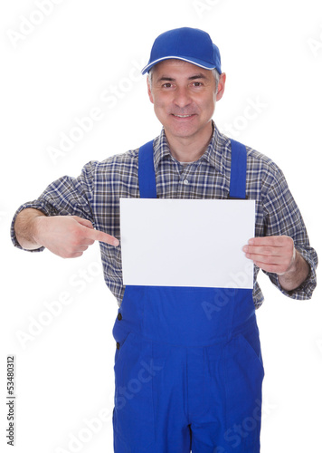 Photo: Mature Male Technician Holding Empty Sheet Mature Male Technician Holding Empty Sheet