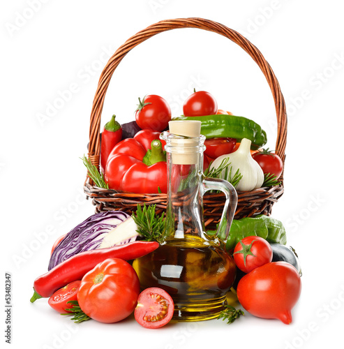 Photo: Vegetables in a basket and olive oil Vegetables in a basket and olive oil
