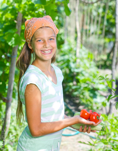 Photo: Girl holding a tomatoes Girl holding a tomatoes
