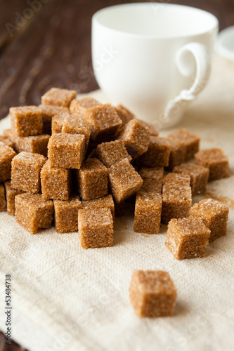 Photo: bunch of raw sugar and white cup bunch of raw sugar and white cup