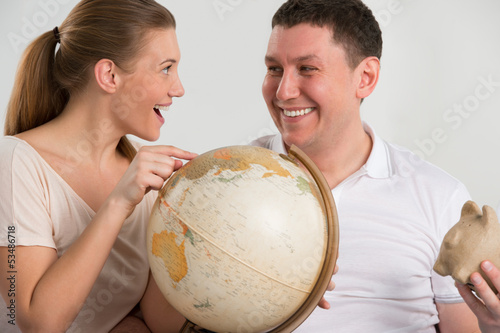 Photo: Portrait of happy romantic couple planning their vacation Portrait of happy romantic couple planning their vacation