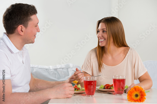 Photo: Happy couple eating vegetable salad Happy couple eating vegetable salad