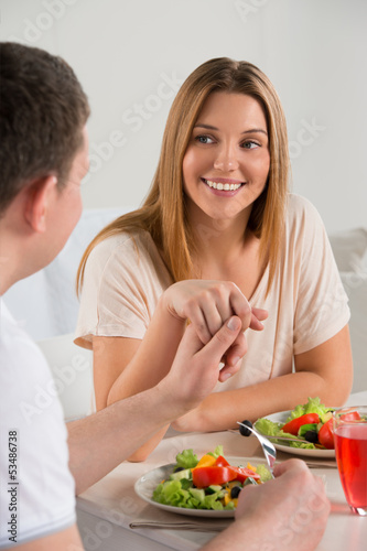 Photo: Young happy couple eating vegetable salad Young happy couple eating vegetable salad