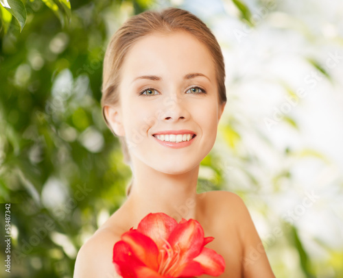 Photo: beautiful woman with red lily flower beautiful woman with red lily flower