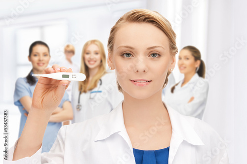 Photo: attractive female doctor with thermometer attractive female doctor with thermometer