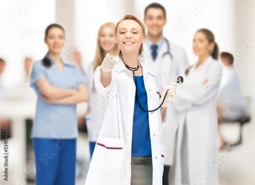 Photo: attractive female doctor pointing her finger attractive female doctor pointing her finger