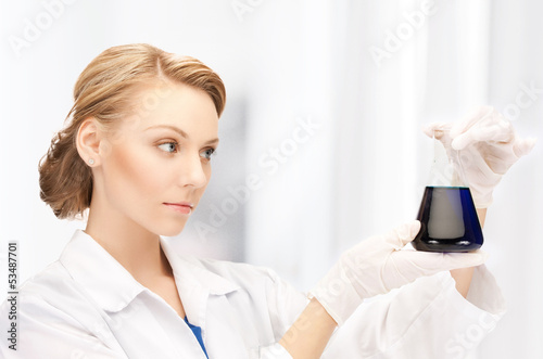 Photo: female chemist holding bulb with chemicals female chemist holding bulb with chemicals