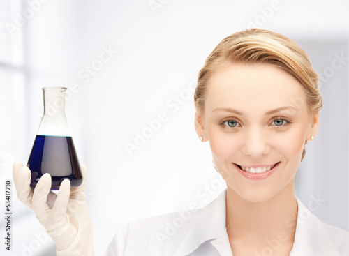 Photo: female chemist holding bulb with chemicals female chemist holding bulb with chemicals
