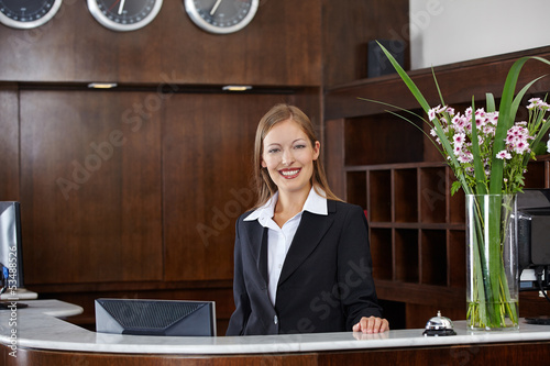 Photo: Happy female receptionist at hotel Happy female receptionist at hotel