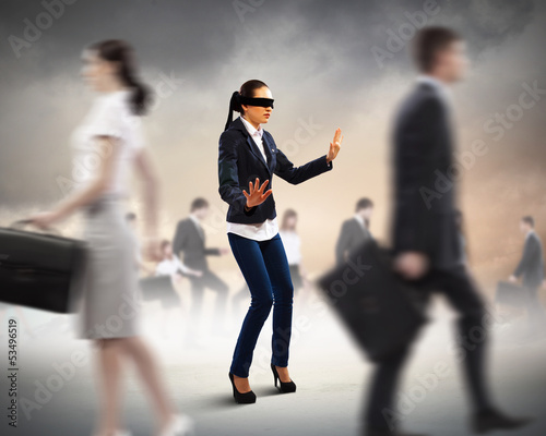 Photo: Businesswoman in blindfold among group of people Businesswoman in blindfold among group of people