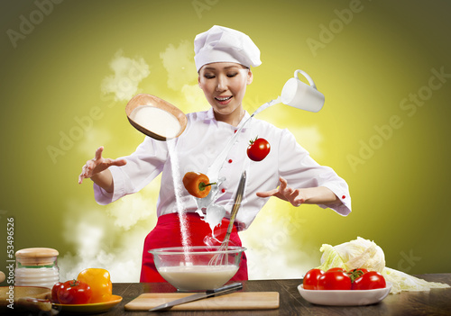 Photo: Asian female cooking with magic Asian female cooking with magic