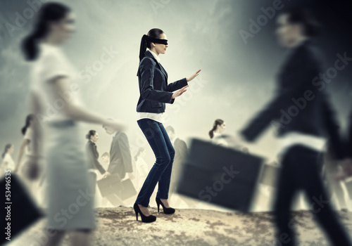 Photo: Businesswoman in blindfold among group of people Businesswoman in blindfold among group of people