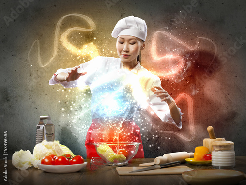Photo: Asian female cooking with magic Asian female cooking with magic