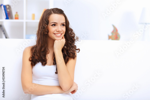 Photo: Young pretty woman in white at home Young pretty woman in white at home