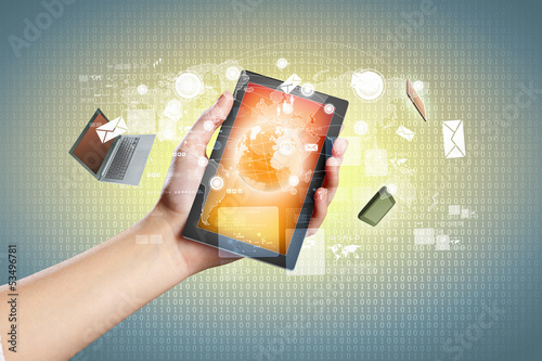 Photo: Close-up of hands holding tablet pc Close-up of hands holding tablet pc